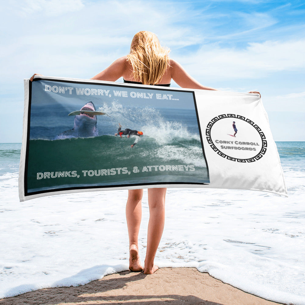 Great white eating a surfer towel with Corky Carroll logo